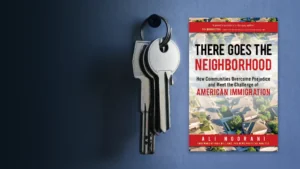 a set of keys hanging on the wall next to a superimposed image of the cover of There Goes the Neighborhood by Ali Noorani