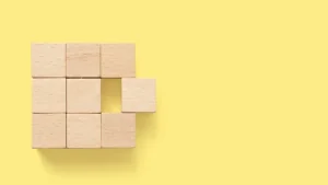 several wooden cubes arranged in a square with one cube sticking out