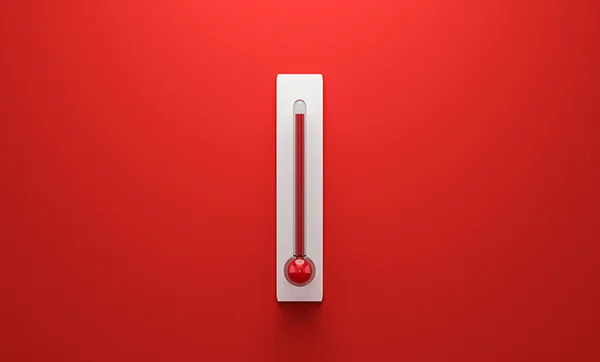 an old style thermometer on a red background