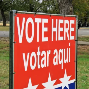 Lawn sign that reads: Vote Here, Votar Aqui