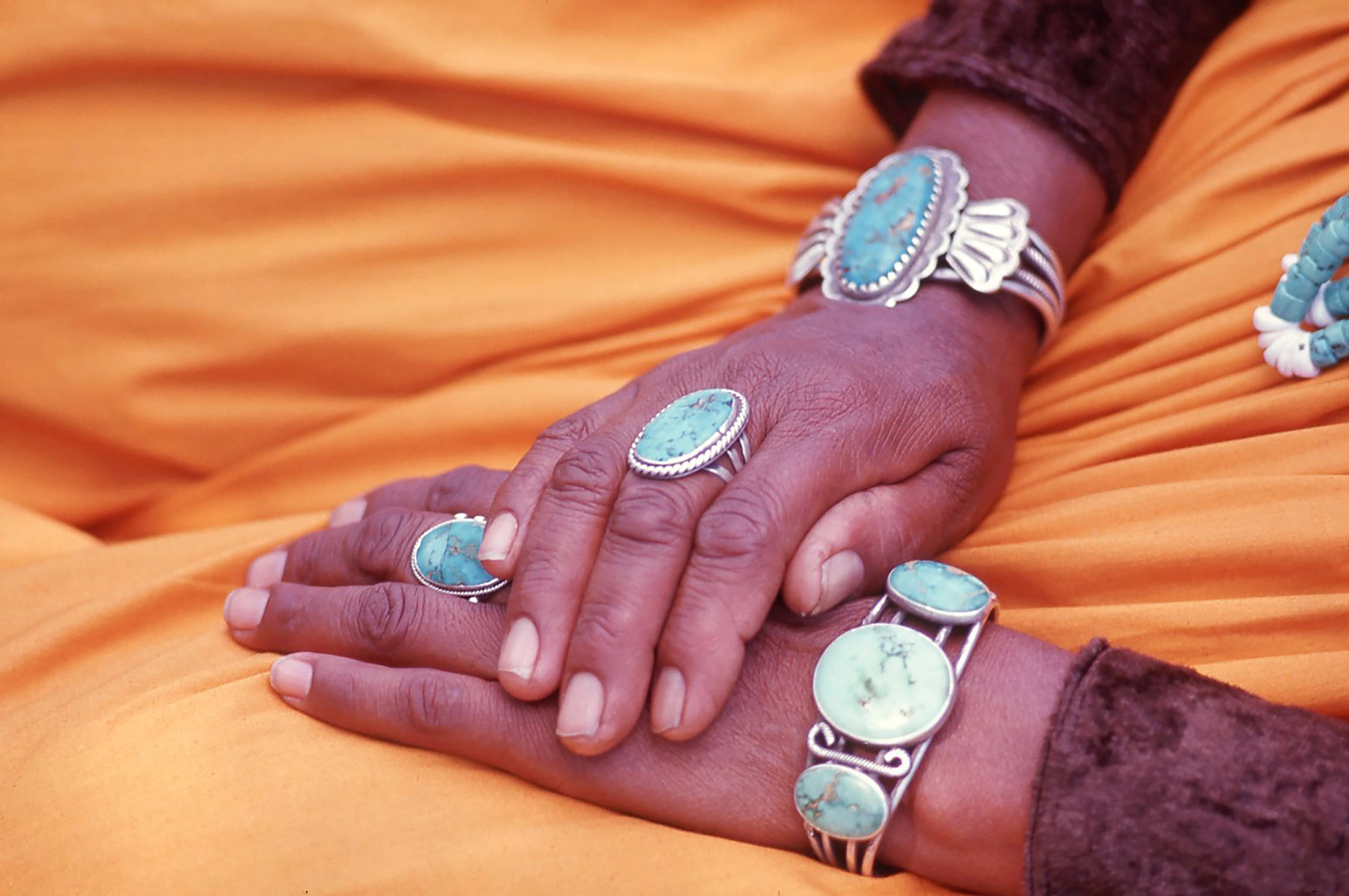 The hands of a Navajo weaver, strong and beautiful, adorned with an incredible array of turquoise rings and bracelets create harmonies blending the colors of earth and sky.