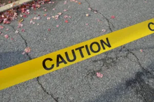 Caution tape against a street background